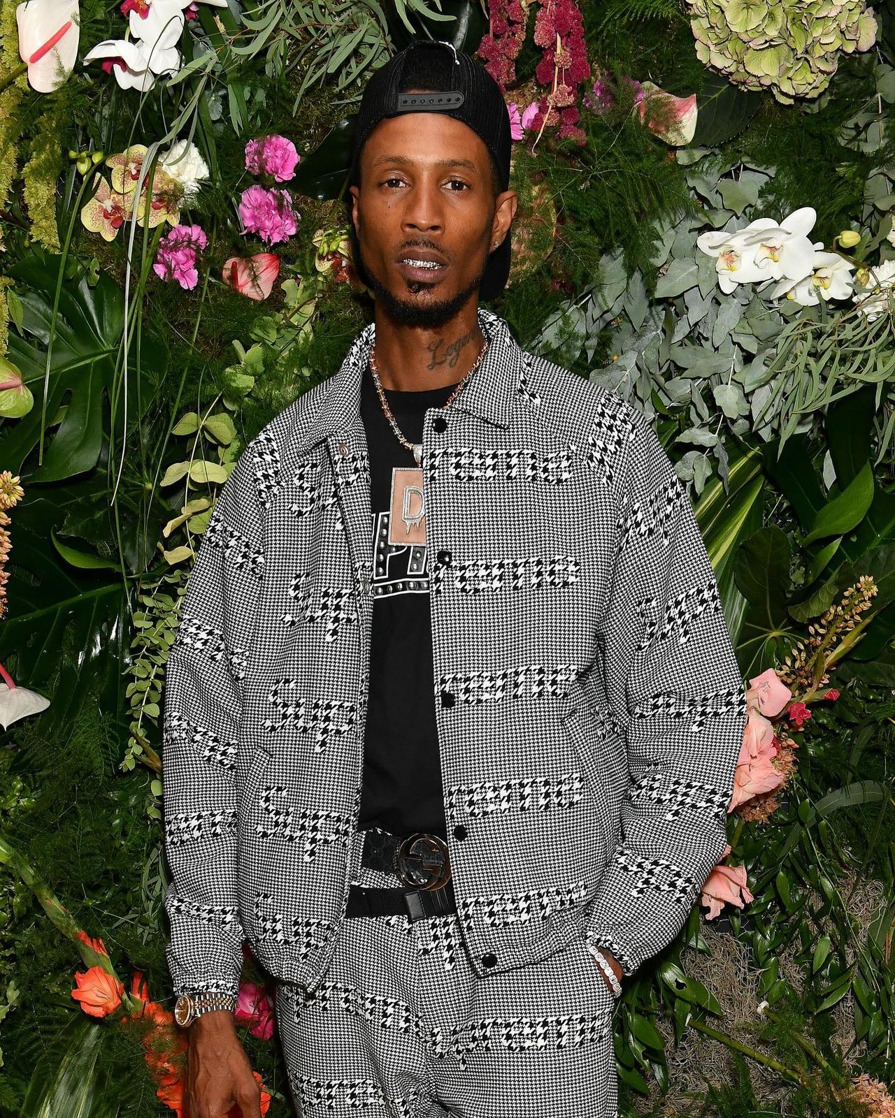 Guest portrait against the floral wall at the Tiffany Calver event.